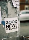 Image of large pole with sign:  Good News is Coming